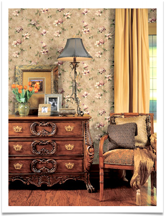 a vintage seating area, chair and chest with lamp, photos,flowers, focus is on wallpaper, vintage